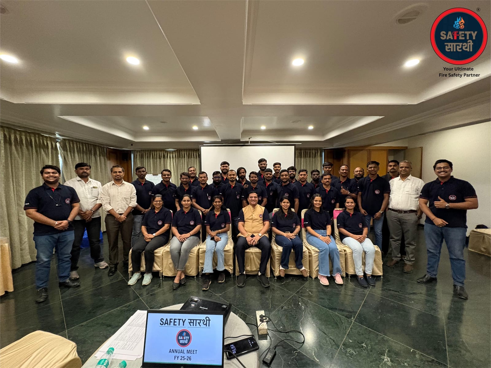 Safety Saarthi Annual Meet FY 25-26, staff in navy polo uniforms posed for a group photo